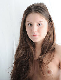 Teen girl with long black hair posing nude